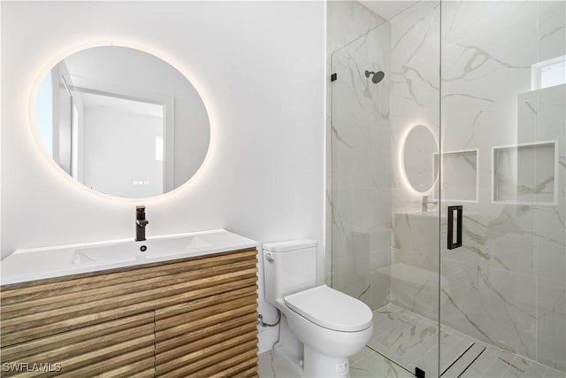 bathroom featuring vanity, an enclosed shower, and toilet