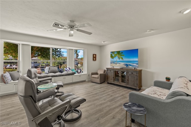 living room featuring ceiling fan and light wood-type flooring