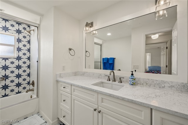 bathroom featuring bathtub / shower combination and vanity