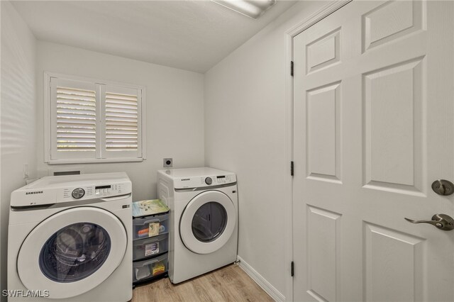 laundry room featuring independent washer and dryer and light wood-type flooring