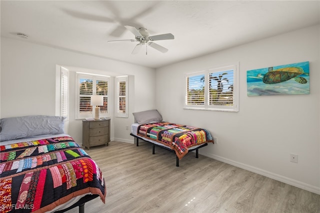 bedroom with ceiling fan and light hardwood / wood-style flooring