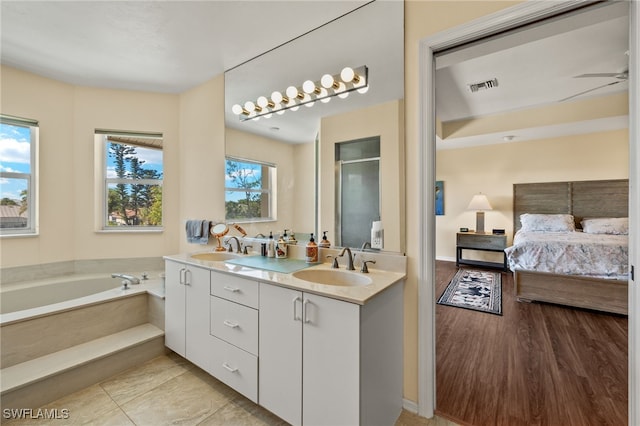 bathroom with ceiling fan, a bathtub, vanity, and wood-type flooring