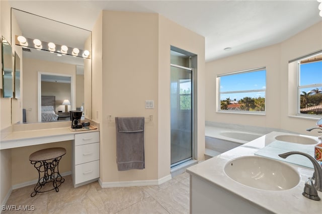 bathroom featuring plus walk in shower, vanity, and a wealth of natural light