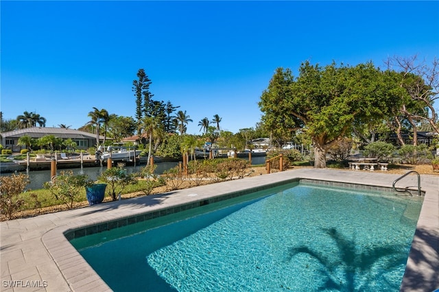 view of pool featuring a water view and a patio