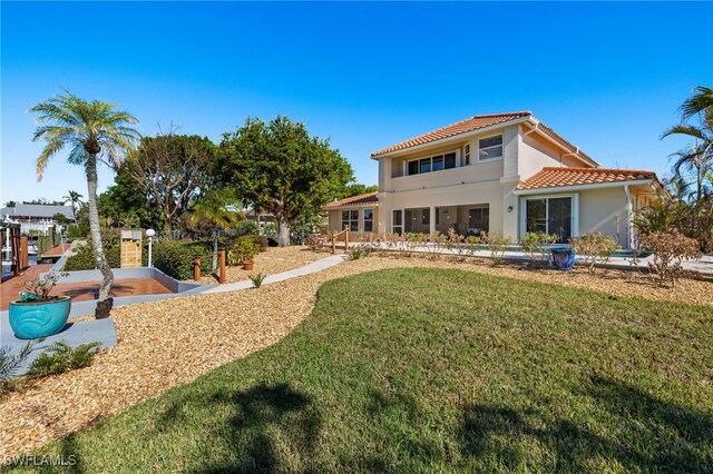 rear view of property with a lawn