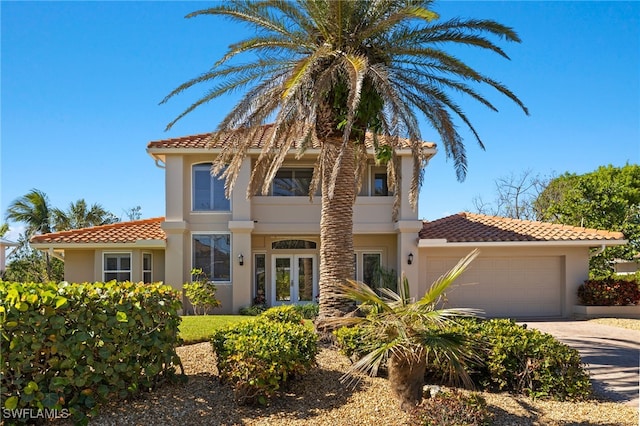 mediterranean / spanish-style home with a garage