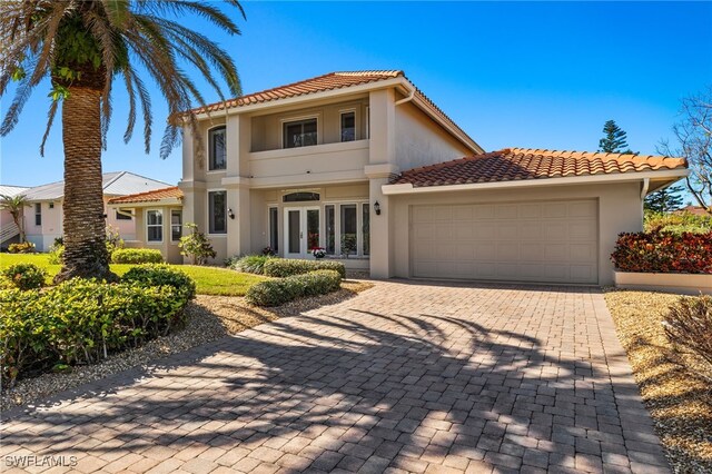 mediterranean / spanish-style house featuring french doors and a garage