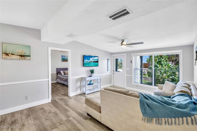 living area featuring ceiling fan, wood finished floors, visible vents, and baseboards