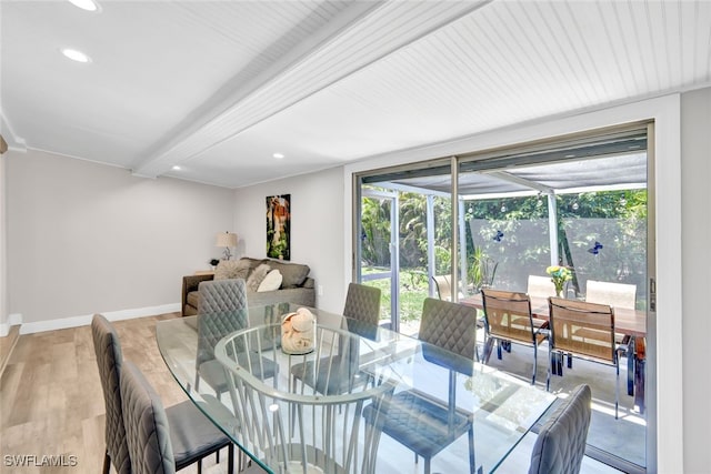 dining space featuring baseboards, a sunroom, beamed ceiling, light wood-type flooring, and recessed lighting