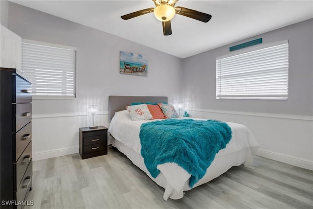 bedroom with ceiling fan and light hardwood / wood-style floors