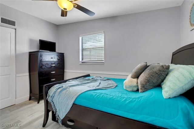 bedroom with ceiling fan and light hardwood / wood-style floors