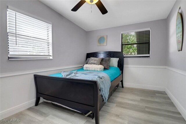 bedroom with light hardwood / wood-style flooring and ceiling fan