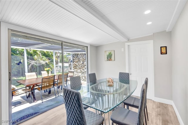 dining room with baseboards, a sunroom, light wood-style floors, beam ceiling, and recessed lighting