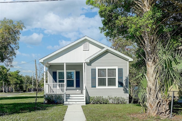 bungalow-style home featuring a front yard and a porch