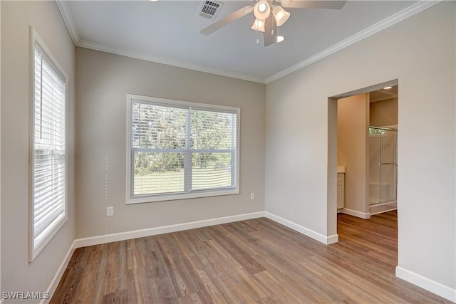 empty room with ceiling fan, light hardwood / wood-style flooring, and ornamental molding