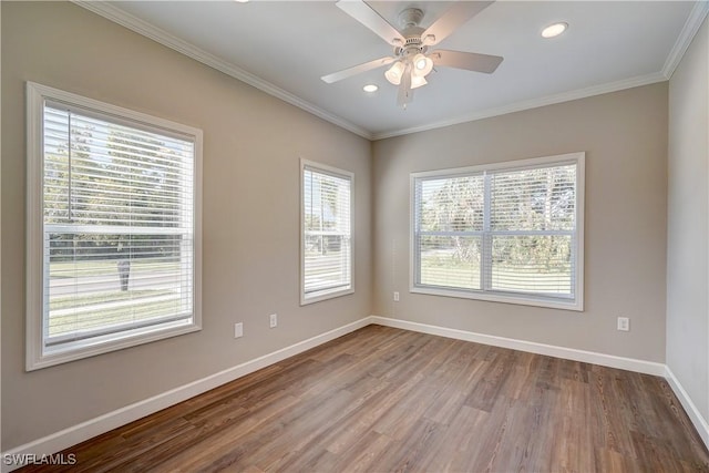 spare room with hardwood / wood-style floors, ceiling fan, and ornamental molding