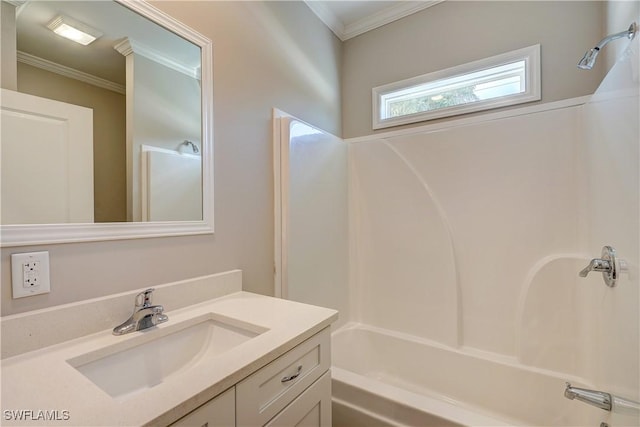 bathroom with shower / bathing tub combination, vanity, and crown molding