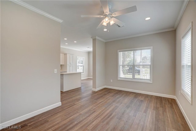 spare room featuring ceiling fan, light hardwood / wood-style floors, and ornamental molding