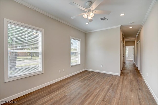 spare room with crown molding, ceiling fan, and light hardwood / wood-style floors