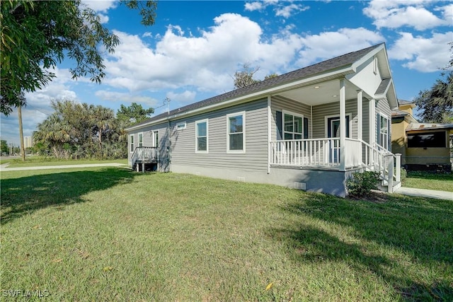 view of side of home with a lawn and a porch