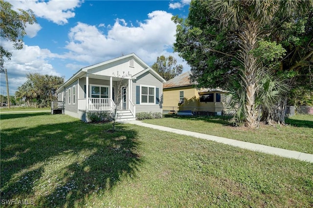 view of front of house with a porch and a front yard