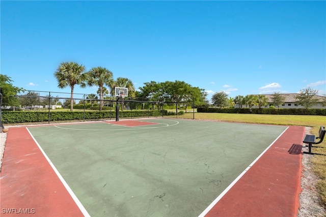 view of basketball court featuring a yard