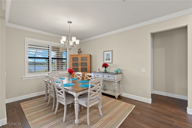 dining space featuring dark hardwood / wood-style flooring, an inviting chandelier, and ornamental molding