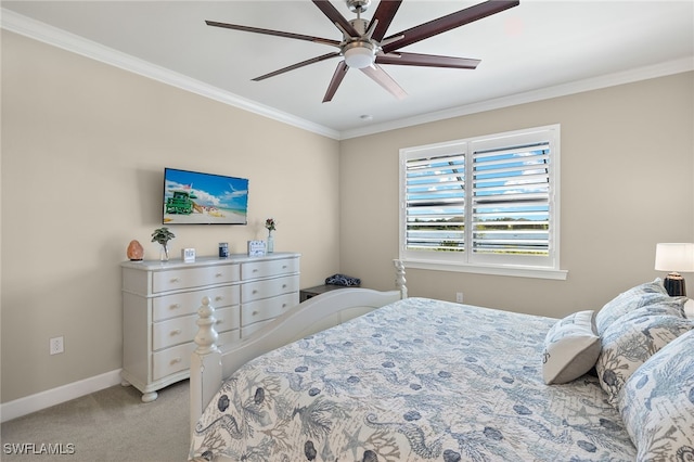 carpeted bedroom featuring ceiling fan and crown molding