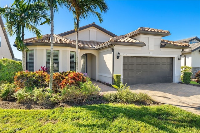 mediterranean / spanish-style house with a garage