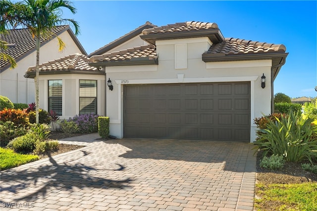 mediterranean / spanish-style house with a garage