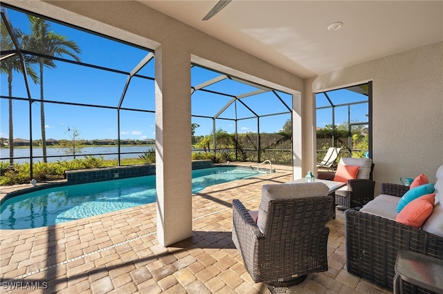 view of swimming pool featuring outdoor lounge area, glass enclosure, a patio area, and a water view