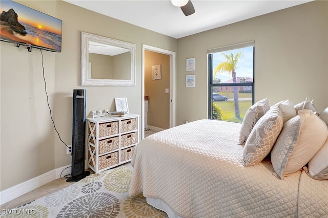 bedroom with tile patterned floors and ceiling fan