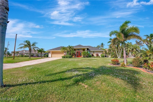 single story home with a garage and a front lawn