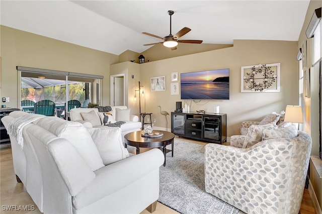 living room with ceiling fan, light hardwood / wood-style flooring, and lofted ceiling