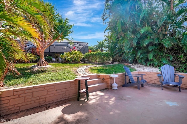 view of patio featuring glass enclosure