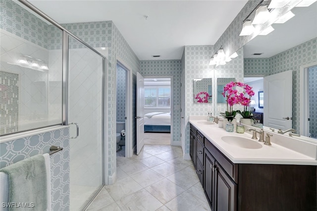 bathroom featuring an enclosed shower, vanity, and toilet