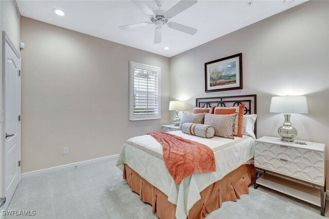 bedroom with ceiling fan and light carpet