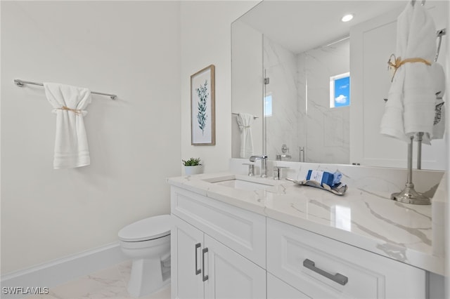 bathroom featuring toilet, vanity, and walk in shower