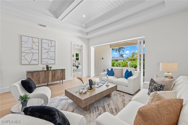 living room with a raised ceiling, wooden ceiling, beam ceiling, and light wood-type flooring