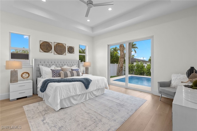 bedroom featuring access to outside, light hardwood / wood-style flooring, and ceiling fan