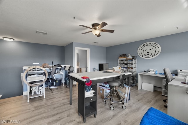 home office featuring ceiling fan and light hardwood / wood-style floors