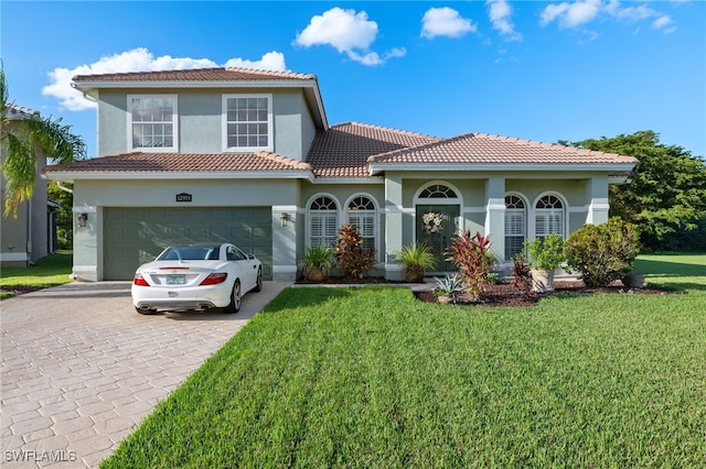 mediterranean / spanish house featuring a front lawn and a garage