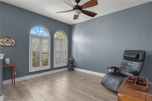 living area featuring ceiling fan and light wood-type flooring