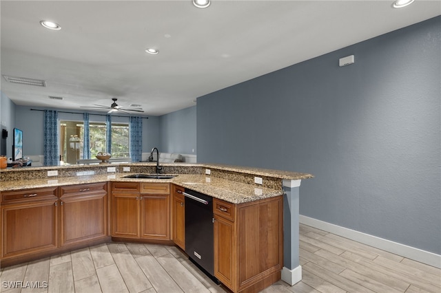 kitchen with sink, light stone countertops, black dishwasher, light hardwood / wood-style floors, and kitchen peninsula