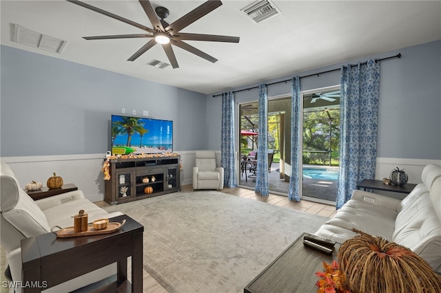 living room featuring ceiling fan and light wood-type flooring