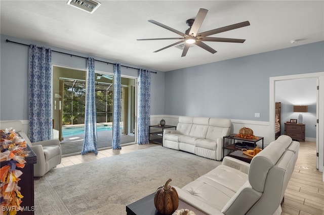 living room with ceiling fan and light wood-type flooring