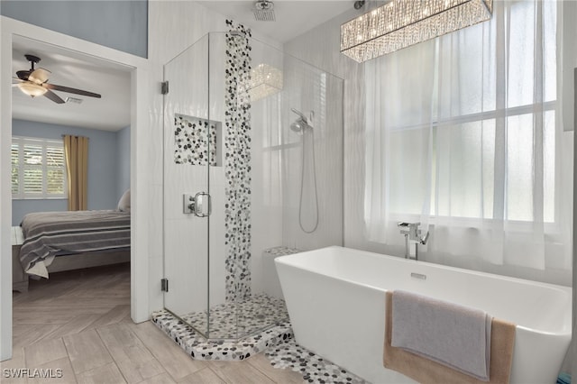 bathroom featuring ceiling fan and shower with separate bathtub