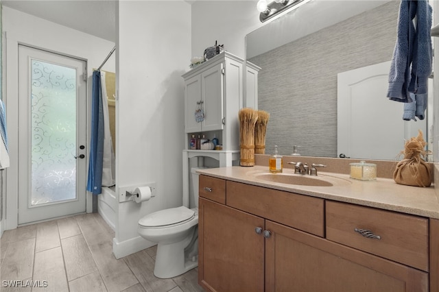 bathroom featuring hardwood / wood-style flooring, vanity, and toilet