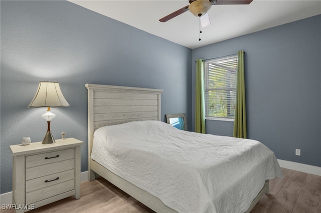 bedroom with ceiling fan and light hardwood / wood-style floors