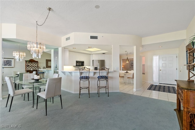 carpeted dining room with a textured ceiling and a notable chandelier